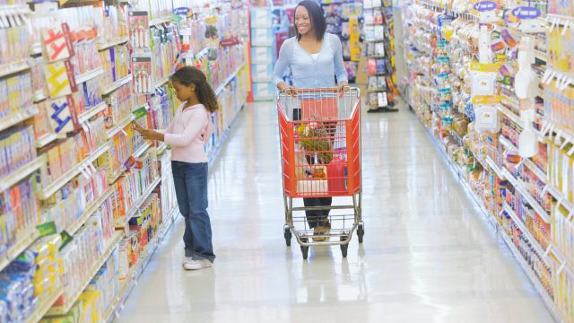 Mother and daughter shopping for groceries in supermarket